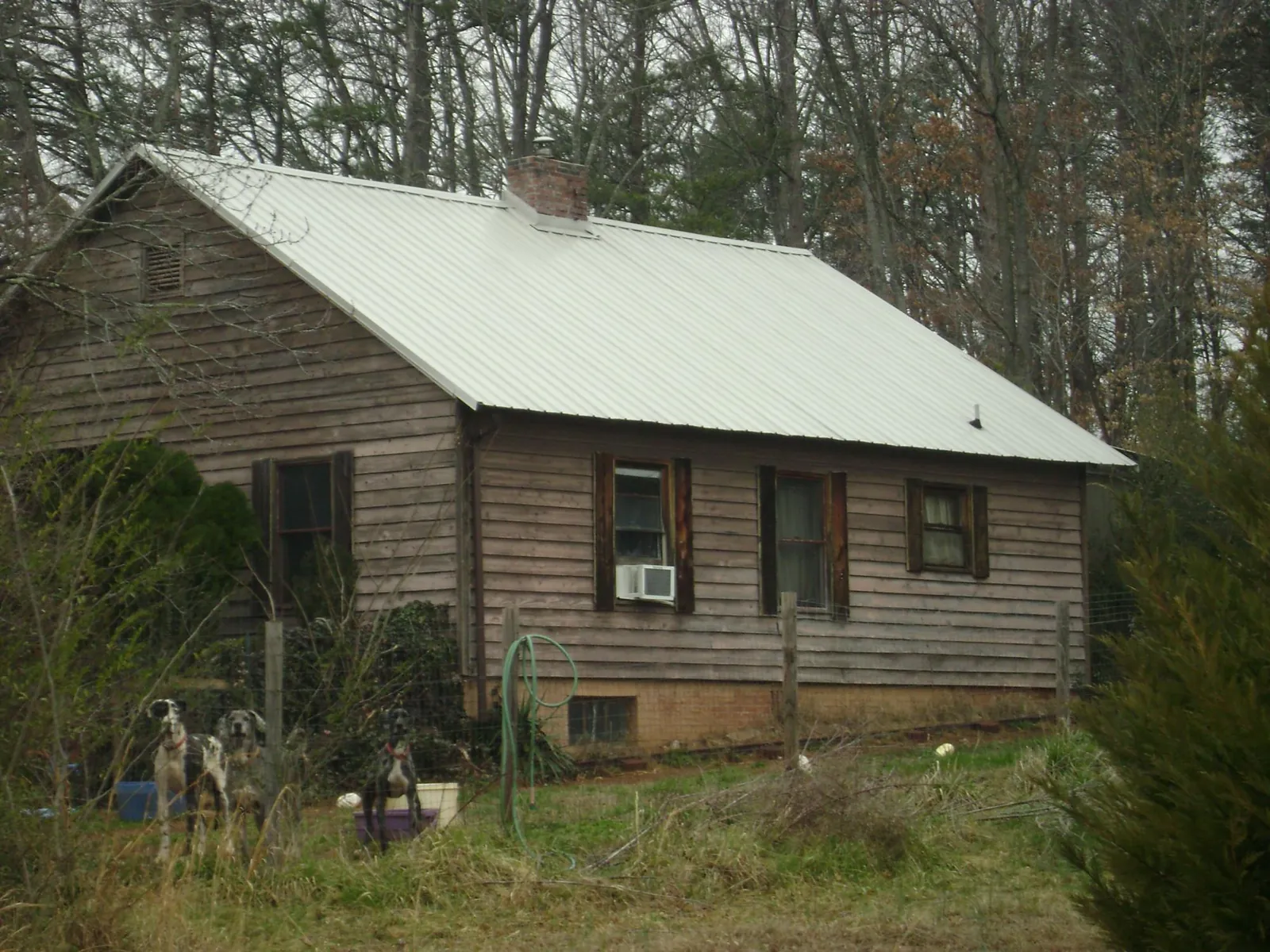 White metal roof on an old wood sided farmhouse, from a Metal Roof Installation job in Buford